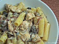 a white bowl filled with pasta and meat