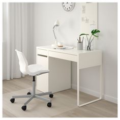 a white desk with a chair next to it