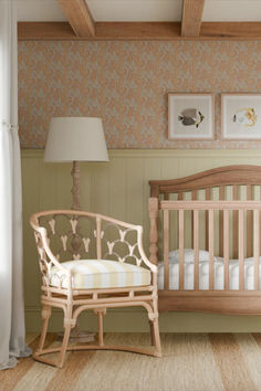 a baby's room with a crib, rocking chair and pictures on the wall