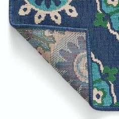 a close up of a tie with blue and green designs on the bottom half of it