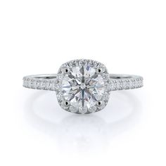 a round brilliant cut diamond ring with pave set shoulders