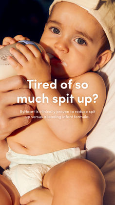 a baby drinking from a bottle while wearing a diaper