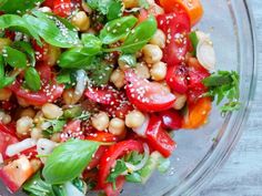 a glass bowl filled with lots of veggies and seasoning on top of it