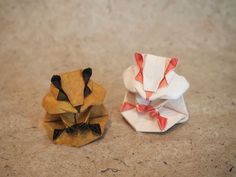 two origami animals sitting next to each other