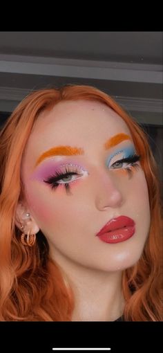 a woman with red hair and bright makeup