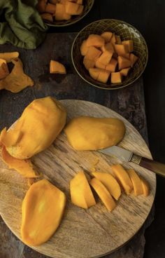 a cutting board with pieces of mango on it