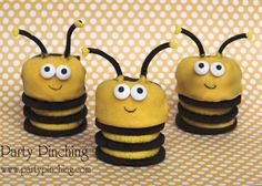 three yellow and black bees with googly eyes sitting on a polka dot tablecloth