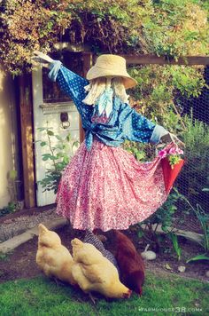 a woman in a dress and hat standing next to chickens