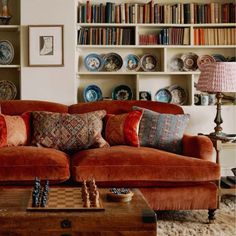 a living room filled with furniture and lots of books