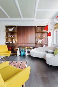 a living room filled with yellow and white furniture