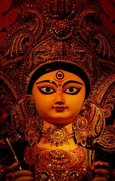 an ornate statue is shown in the dark with bright lights on it's face