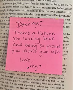 a piece of pink paper with writing on it