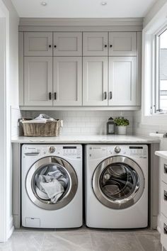 a washer and dryer in a white laundry room with gray tile flooring