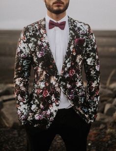 a man wearing a floral suit and bow tie