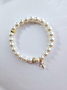 This beautiful bracelet is made with 8mm white Austrian crystal pearls and 14 kt gold filled white pearl cross charm. This bracelet is sold gift wrapped Elegant White Cross Bracelets, Elegant White Cross Bracelet, Elegant White Charm Bracelet With 8mm Beads, Pearl Rosary Bracelet With Pearl Charm, Pearl Rosary Bracelet With Round Beads And Pearl Charm, Elegant Pearl Rosary Bracelet For Baptism, White Pearl Charm Bracelet, White Hypoallergenic Pearl Bracelet For First Communion, Hypoallergenic White Pearl Bracelet For First Communion