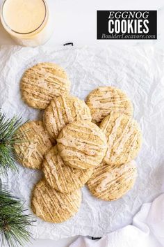 eggnog cookies are piled on top of each other next to a glass of milk