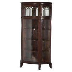 an antique wooden display case with glass doors and metal bars on the top, in dark wood