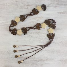 a rosary with gold stars and brown cord