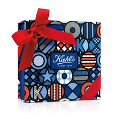 a blue gift bag with red ribbon on it