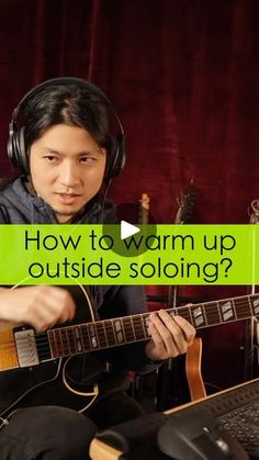 a person with headphones on playing an acoustic guitar and the words how to warm up outside soloing?