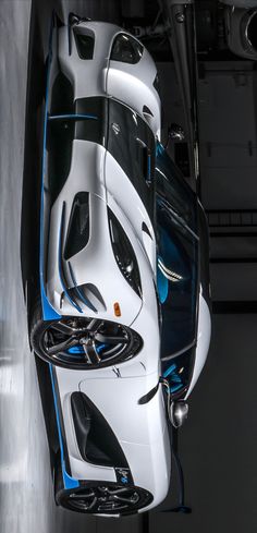 a white and blue sports car parked in a garage