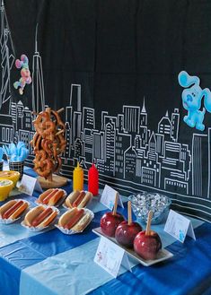 a table topped with hot dogs and pretzels