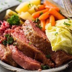 a close up of a plate of food with meat and vegetables