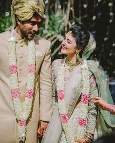 a bride and groom standing next to each other