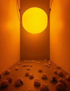 a room with rocks on the floor and an orange light