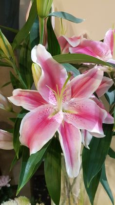 a vase filled with pink and white flowers