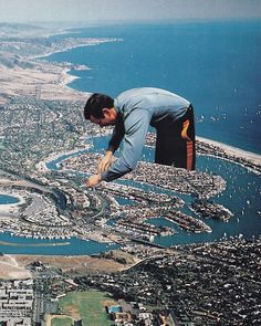 a man flying through the air over a city