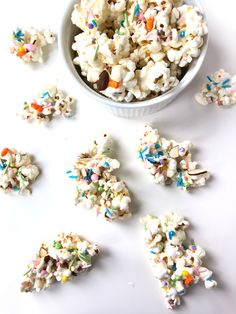 white chocolate popcorn with sprinkles in a bowl and scattered confetti