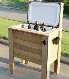 an outdoor cooler with beer bottles in it