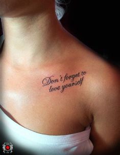 a woman with a tattoo on her chest saying don't forget to love yourself