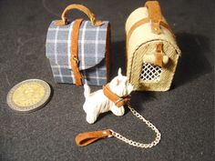 a small toy dog is next to a purse