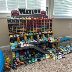 a toy store with cars and toys on the floor in front of it's display