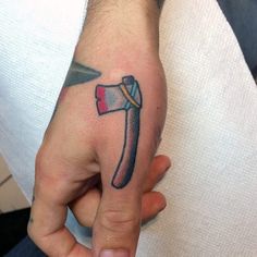 a person with a tattoo on their hand holding a knife