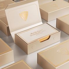 several boxes with gold foil on them are arranged in the shape of an arrow and diamond