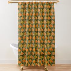 an orange and green shower curtain hanging on a wall next to a white bathtub