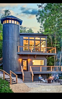 this is an image of a modern house in the woods at sunset or sunrise time