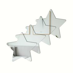 three star shaped mirrors hanging on the wall in front of a white background with gold trim