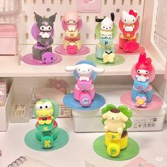 there are many toy figures on display in the store, including hello kitty and other toys