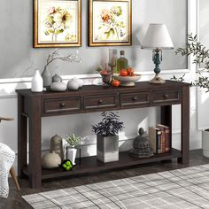 a wooden table topped with two vases filled with flowers