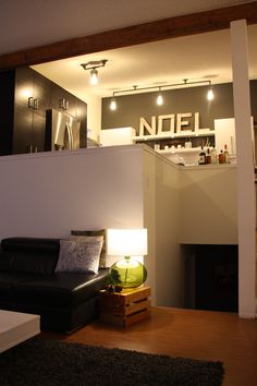 a living room filled with furniture next to a kitchen