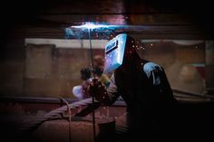 a man is welding something in the dark