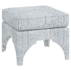 a grey and white patterned stool with legs