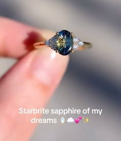 someone is holding a ring with a blue diamond in it and the words startrite sapphire of my dreams