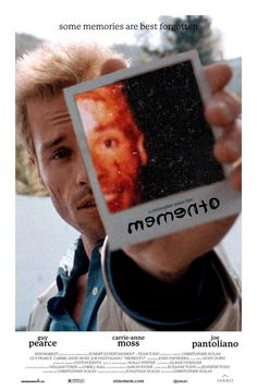 a man holding up a polaroid in front of his face with the caption's name on it