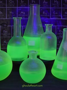 glowing green flasks and beakles on a table