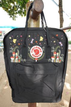 Welcome to our charming collection of hand-embroidered Fjallraven Kanken backpacks, meticulously crafted with love and precision. Elevate your style and stay organized on-the-go with these premium quality backpacks available in two convenient sizes:  - Medium (27x38x13cm)  - Large (32x42x13cm) + Key Features: - Hand-Embroidered Excellence: Each Fjallraven Kanken backpack is adorned with exquisite hand-embroidery, creating a unique and exclusive piece that sets you apart from the crowd. - Premium Embroidered Kanken, Kanken Embroidery, Mochila Fjallraven Kanken, Fjallraven Backpack, Mushrooms Forest, Kanken Classic, Backpack Fjallraven, Embroidered Backpack, Embroidery Bags